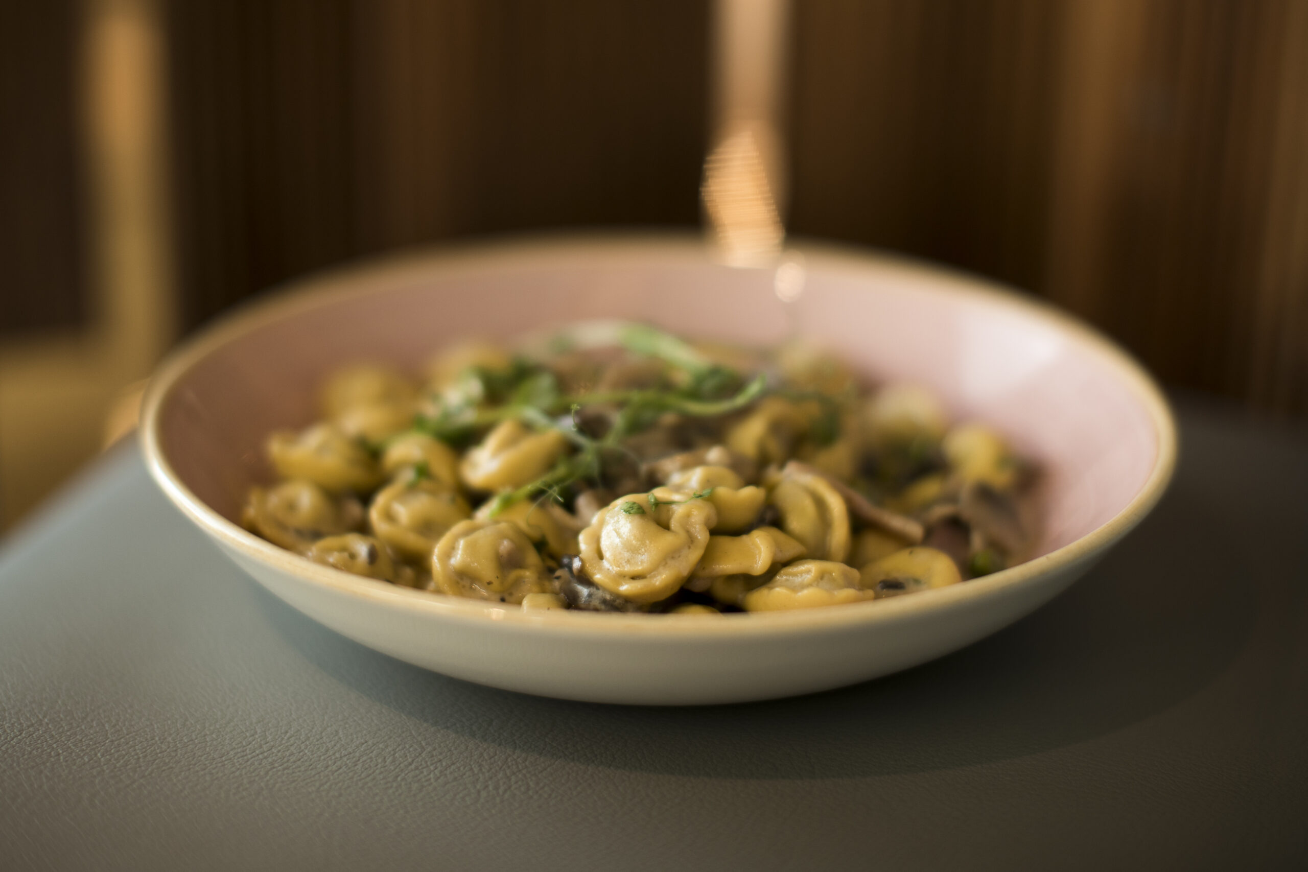 Tortellini alla Crema with Fresh Cream, Mushrooms, Peas, Ham & Bacon